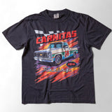 Taco Gear Carnitas Racing t-shirt featuring vintage pickup truck graphic, bold “Carnitas” text, and retro racing design on black and blue tees.