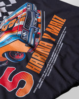 Taco Gear Tres de Asada Racing t-shirt featuring vintage racecar graphic, bold “Harina y Maíz” text, and checkered flag design on black and green tees.