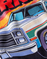 Taco Gear Carnitas Racing t-shirt featuring vintage pickup truck graphic, bold “Carnitas” text, and retro racing design on black and blue tees.