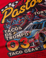 Taco Gear Al Pastor Racing t-shirt with colorful taco-themed racecar graphic, devil driver, and bold “Tacos de Trompo” and “Racing” text on navy and red tees.
